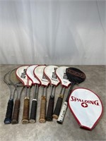 Assortment of tennis rackets, most are Wilson