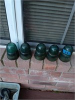 5 green glass insulators