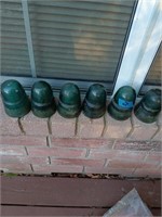 6 green glass insulators