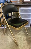 Gold and black folding metal chair     1941