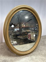 Oval framed mirror