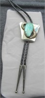 Bolo tie with large turquoise stone.