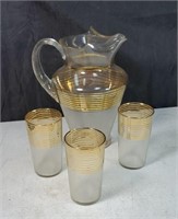Goldtone pitcher and 3 glasses