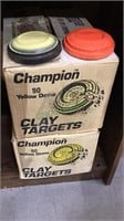 Two boxes of dome clay targets for shooting, one