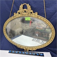 Oval gold colored mirror 28x26