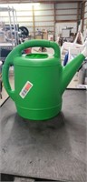 Green plastic watering jug