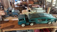 3 vintage metal toy trucks, includes a structure,