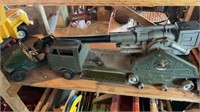 Large army truck missing some wheels, and a green