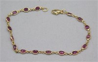 14K 6 5/8" BRACELET WITH 2.00 CTS TW RUBIES.