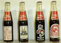 EIGHT COMMEMORATIVE COKE BOTTLES