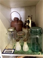 Collection of tin jugs, crock, skates, jars, and