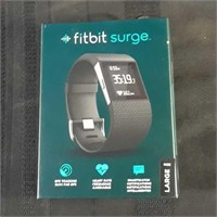 Fitbit Surge. Powers on. With charging cord in