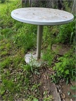 Round outdoor table with metal base
