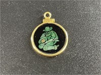 Small pendant with an jade scene depicting a gold