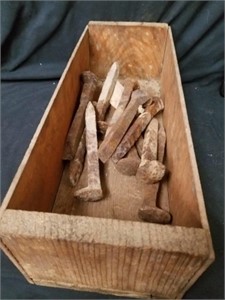 Wooden box with 12 railroad spikes
