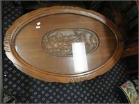 Carved walnut coffee table with relief design,