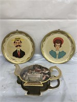 Two vintage metal trays one of a man with a