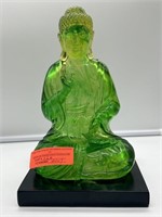 Resin Buddha statue on wood base. 6x11in.