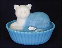 Blue slag glass covered kitten on nest