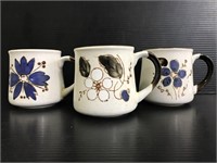 Three stoneware floral mugs