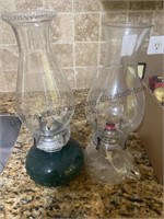 2 oil lamps , one with a clear base and one with