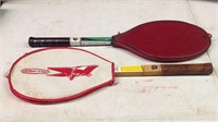 Two vintage tennis rackets with covers