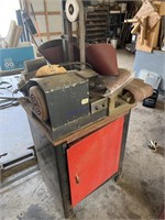 Belt sander on table with contents