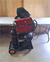 Lincoln Electric MIG PAK 10 on cart with helmets