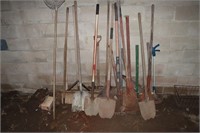 Lot of yard tools including shovels, rakes, hoes