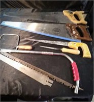Assorted saws, two hand saws, one hacksaw, and