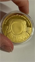 Moon landing commemorative token golden in clear