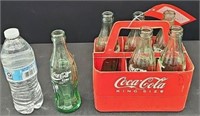 (6) Coca Cola bottles in plastic Coca Cola carrier