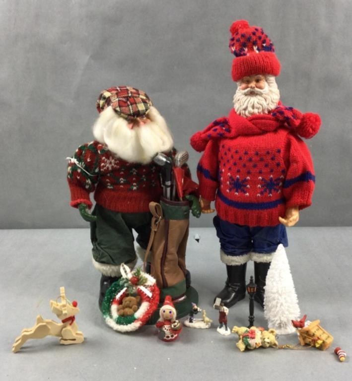 2 Santa statues with other Christmas decorations