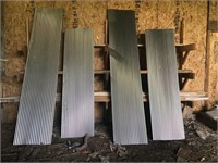 Four sheets of ribbed galvanised metal