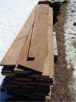 Large pallet of rough sawn lumber; most are approx