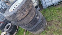 Five ST235/80R16 tires on rims