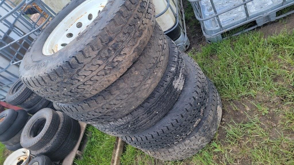 Five ST235/80R16 tires on rims