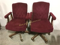 2 maroon rolling office chairs with nail head trim