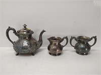 Silver tea set with cream and sugar and teapot