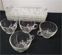 Four snack plates with cups