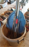 plastic trash can w/long bows and fishing poles