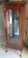 Glass curio cabinet with glass shelves.