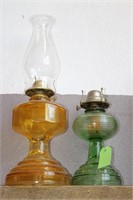 GREEN AND AMBER COLORED OIL LANTERNS
