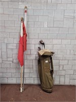 2 Canadian flags and gold bag with clubs