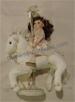 Porcelain doll on carousel horse