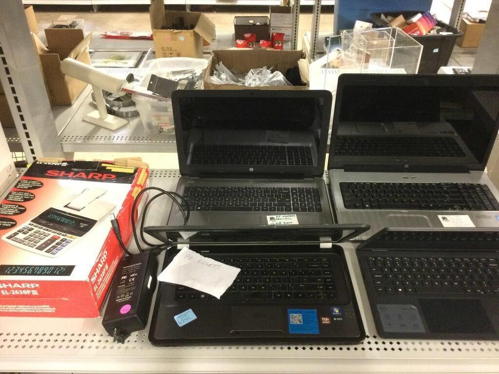 Sharp desktop calculator and assorted laptops.