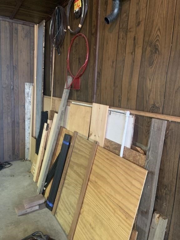Assorted lumber & miscellaneous items in corner