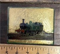 Glass paperweight with train image
