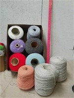 Group of large machine spools of yarn