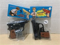 Shooting Pistols, pair, (vintage-marked 49 cents)